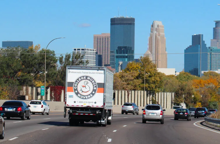 A College Muscle Movers truck carrying a shipment  for an interstate relocation