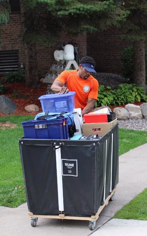 Basket Truck for Apartment Moves A mover using a basket truck to move boxes and loose items into an apartment building in St. Paul.
