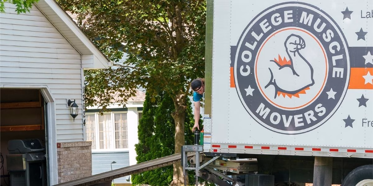 A College Muscle Movers truck in the driveway of a house in the Twin Cities.