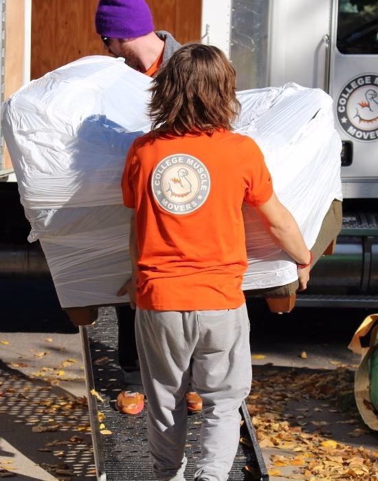 Movers carrying furniture during a move in fall in the Twin Cities, Minnesota