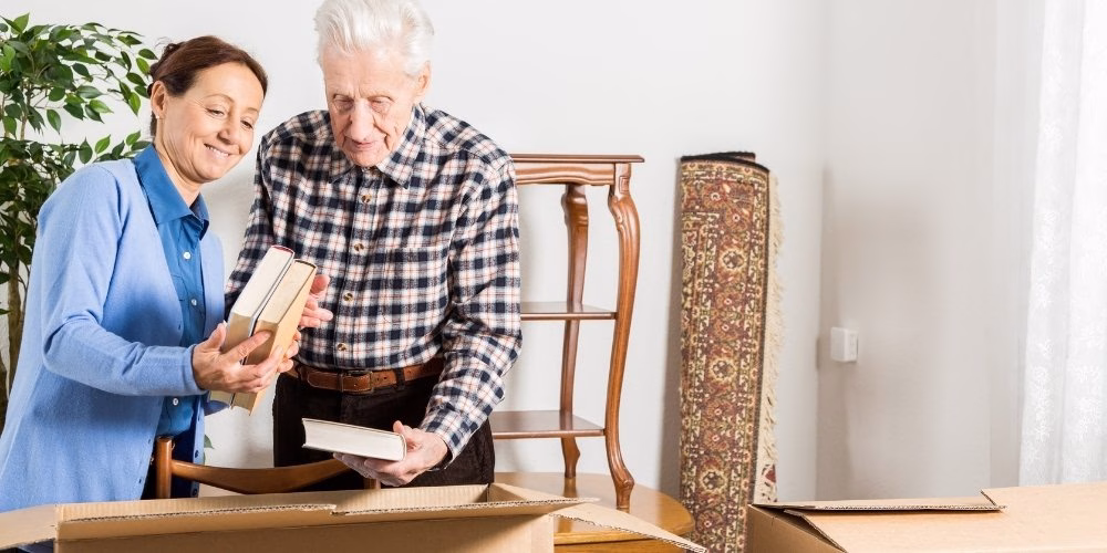 Helping a Parent Downsize or Move to Senior Living An adult woman helping a parent downsize and move to Senior Living